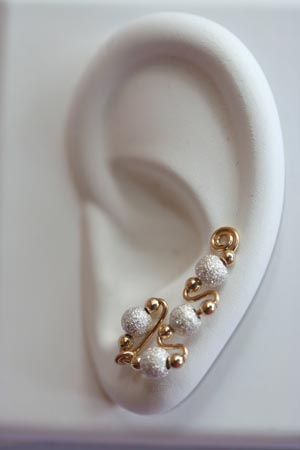 These earrings give the impression of multiple piercings even though there 